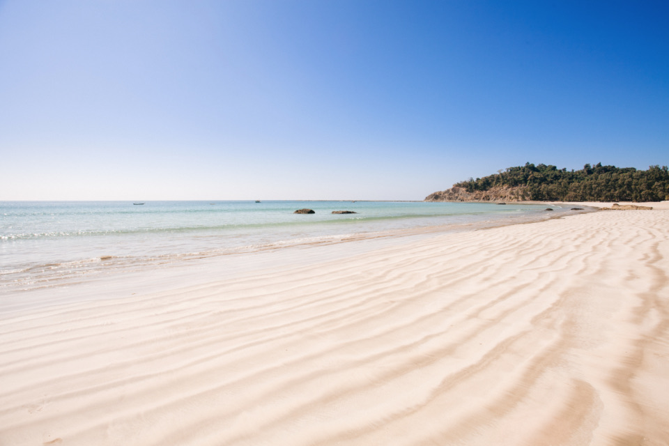 หาดทรายขาวละเอียดกับน้ำทะเลใส ฟ้าสีฟ้าสด